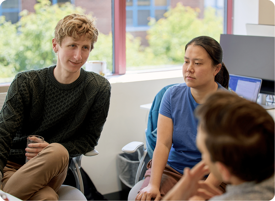 Team members sitting in a circle talking